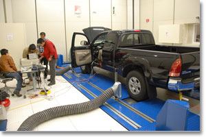 AuE893 students measuring a truck on the chassis dynamometer