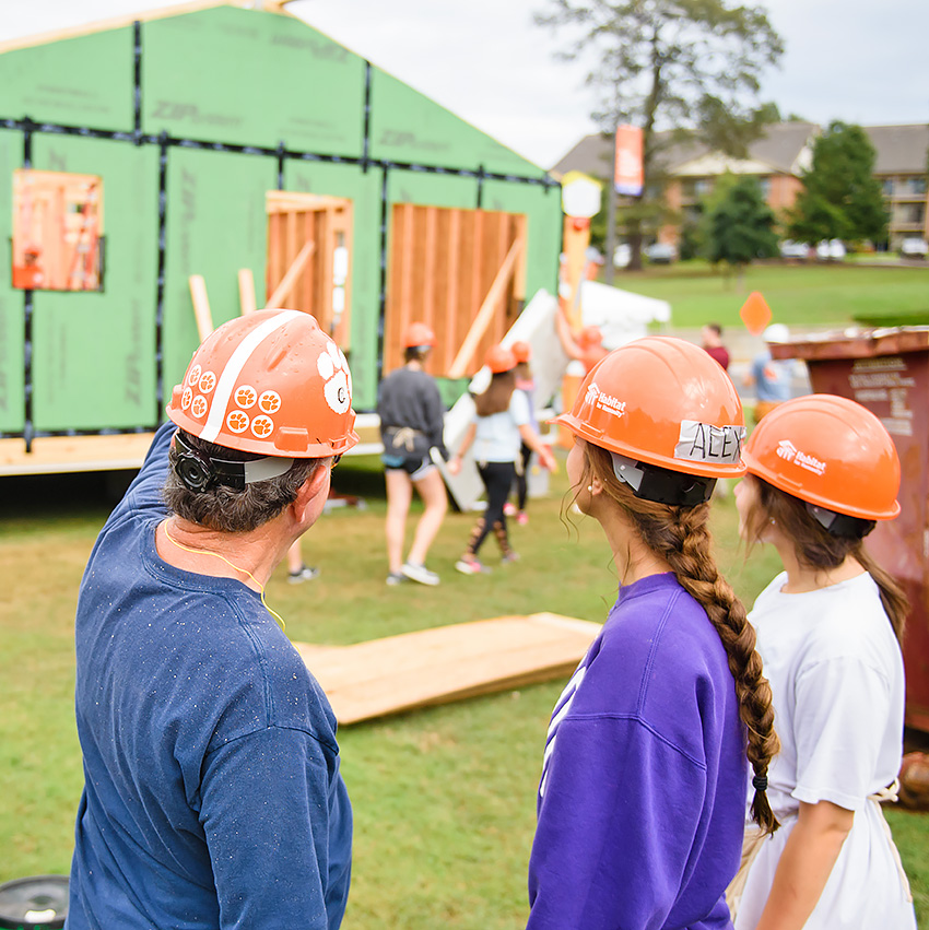 Student participating in house build